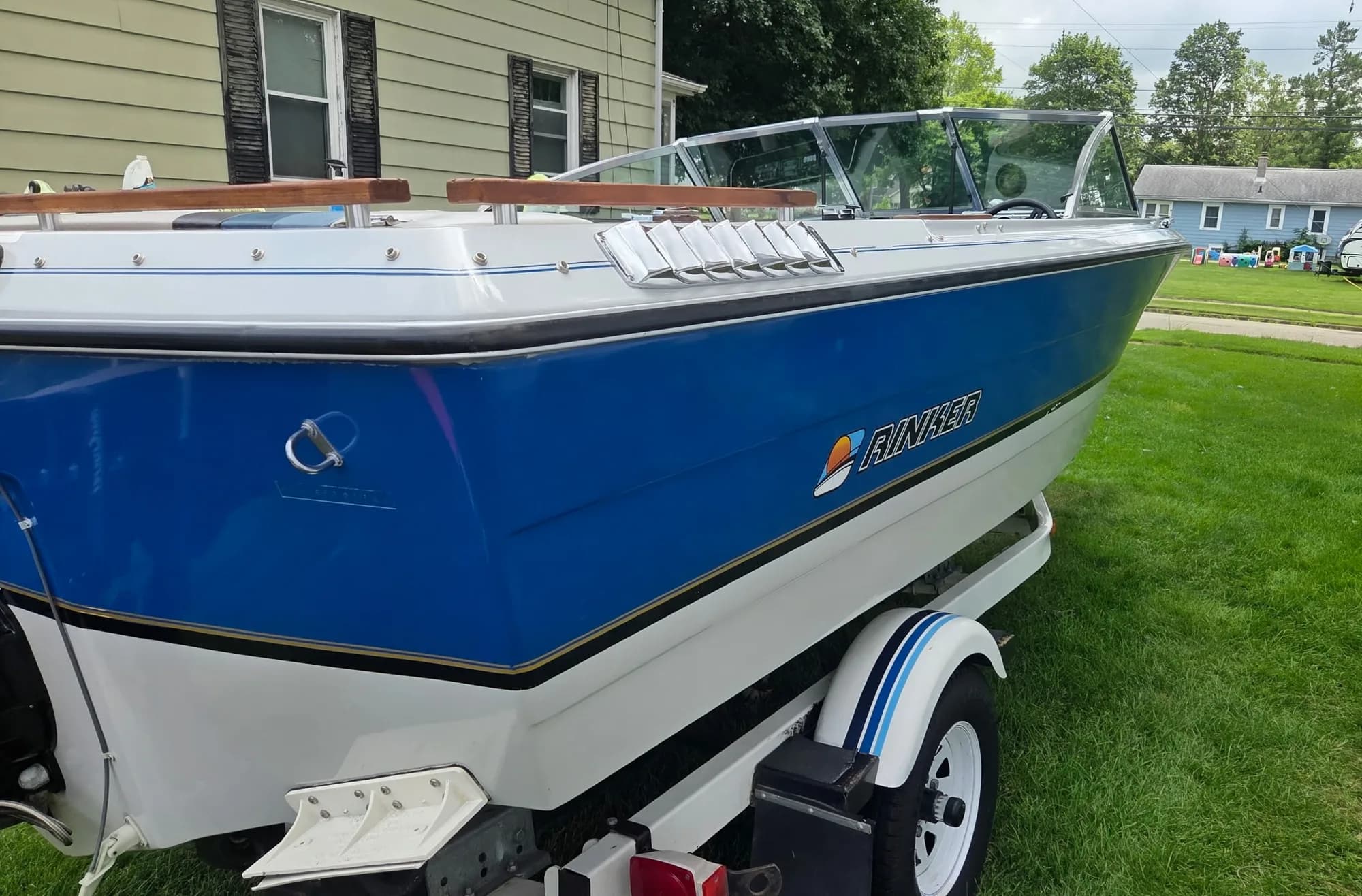 Blue and white boat on a trailer after gel coat correction and coating
