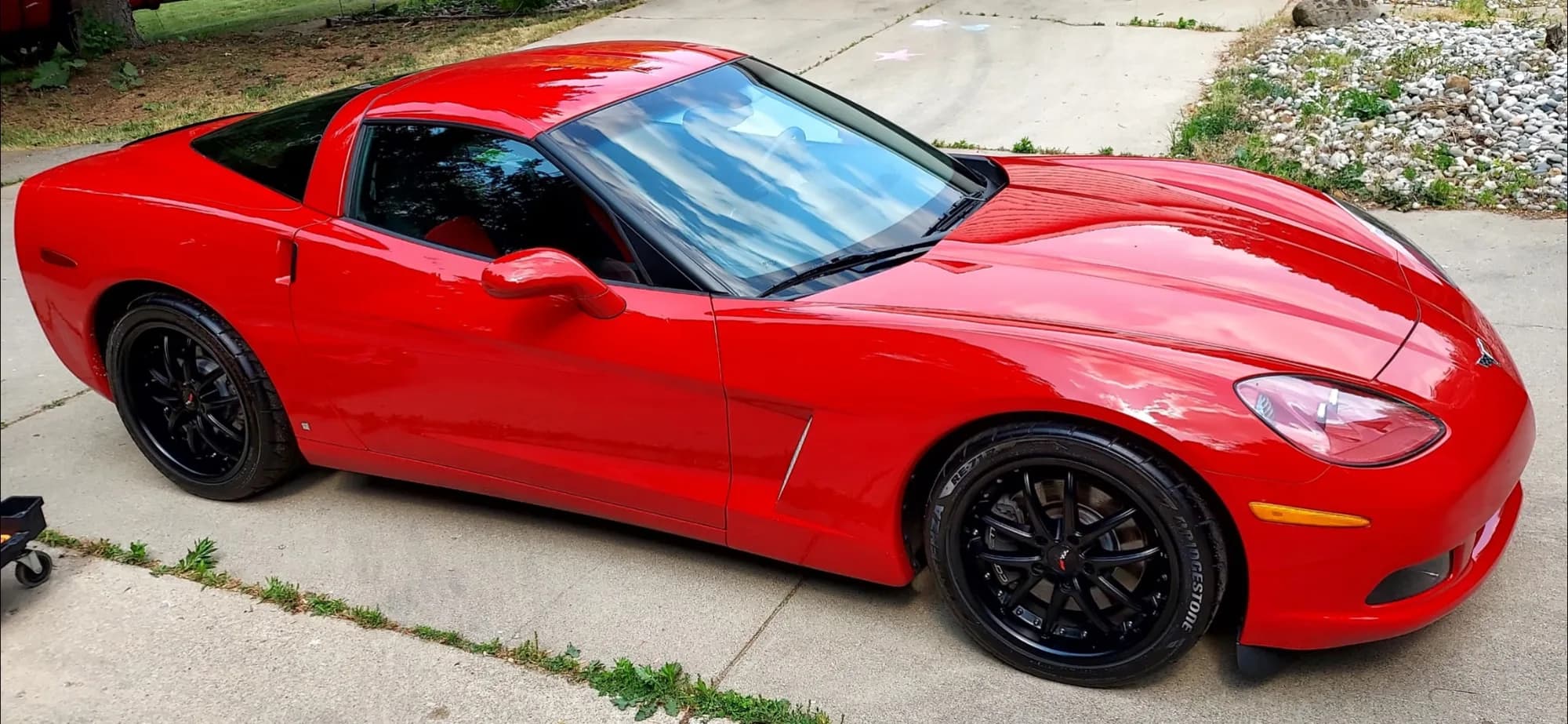 Red Corvette C6 in a driveway after a ceramic coating